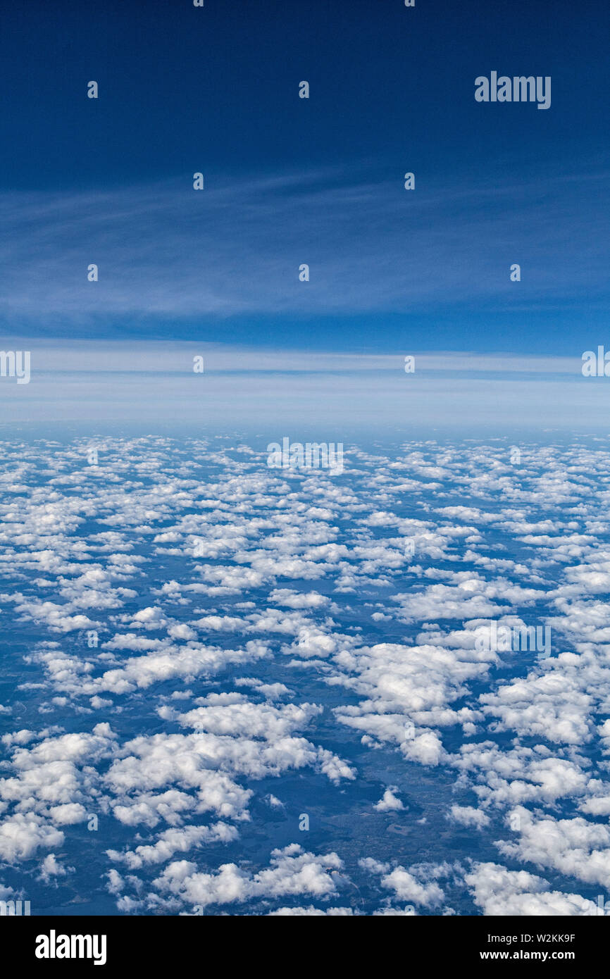 white puffy clouds seen from and airplane Stock Photo