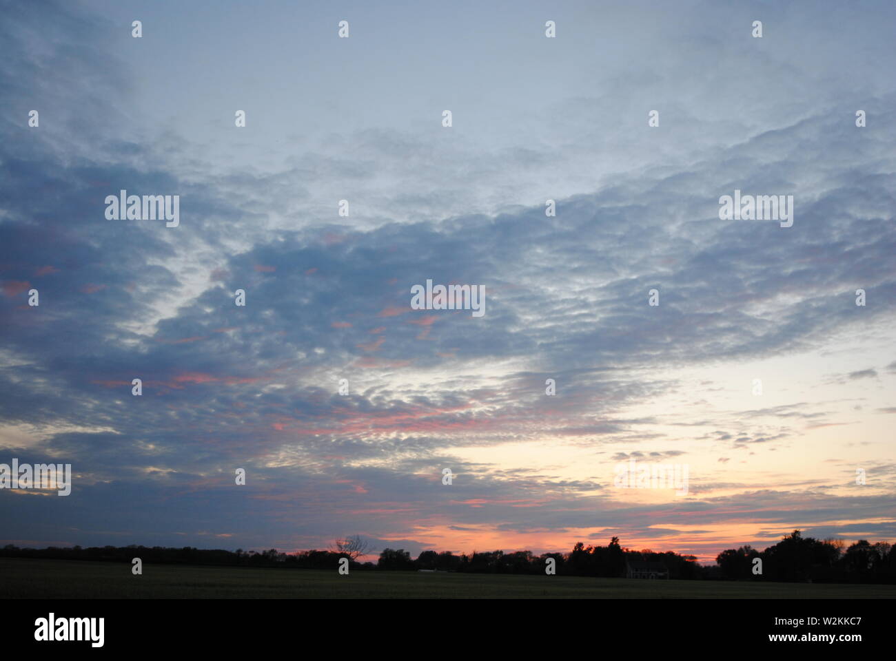 A sunset with thin layer of clouds in the sky Stock Photo - Alamy