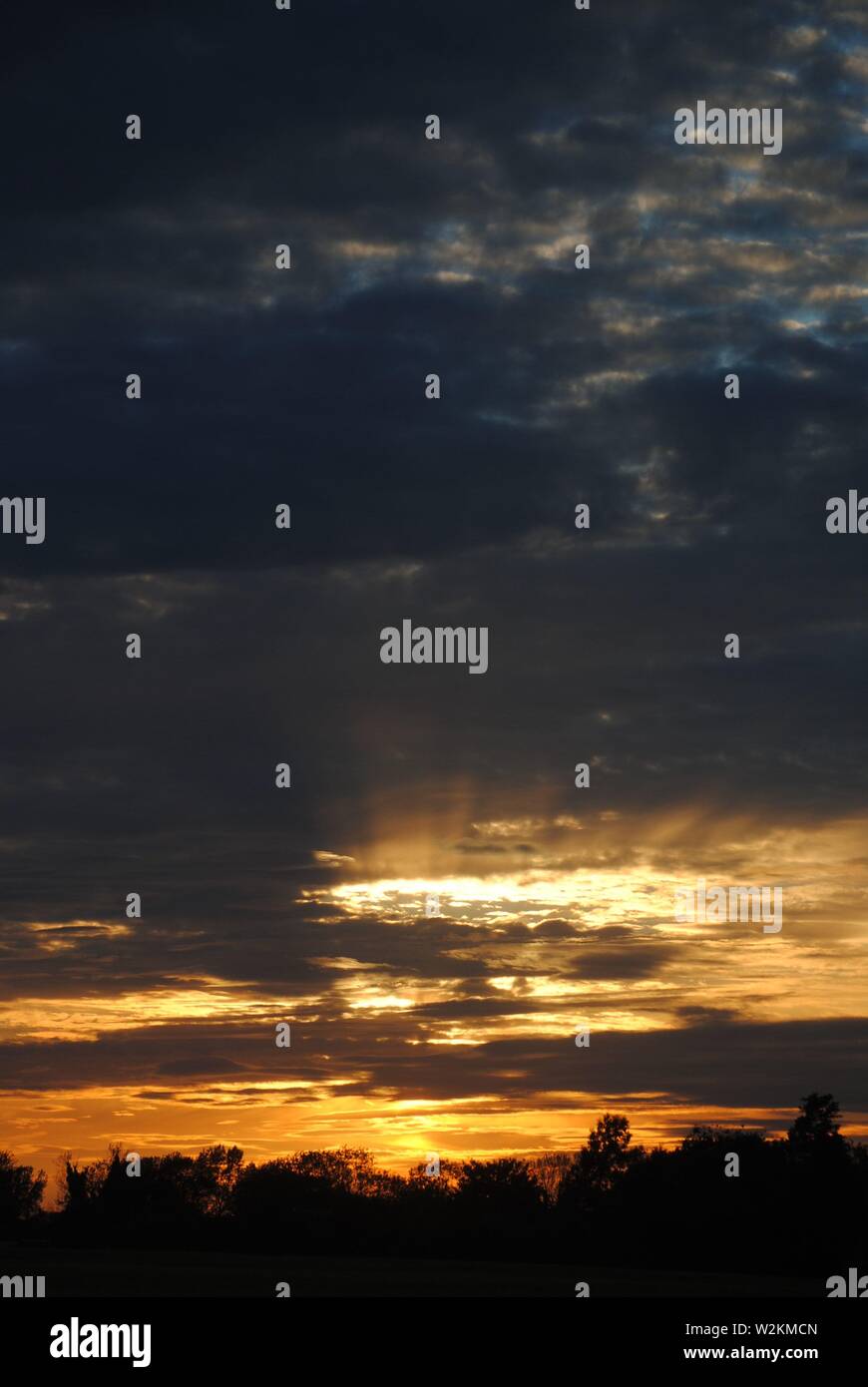 A sunset with thin layer of clouds in the sky Stock Photo - Alamy