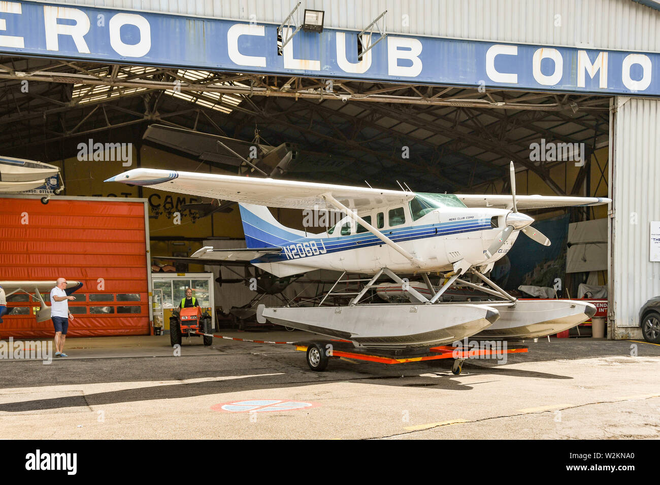 COMO, LAKE COMO, ITALY - JUNE 2019: Floatplane operated by the Aero Club Como being pushed from the hangar in the town of Como on Lake Como. Stock Photo