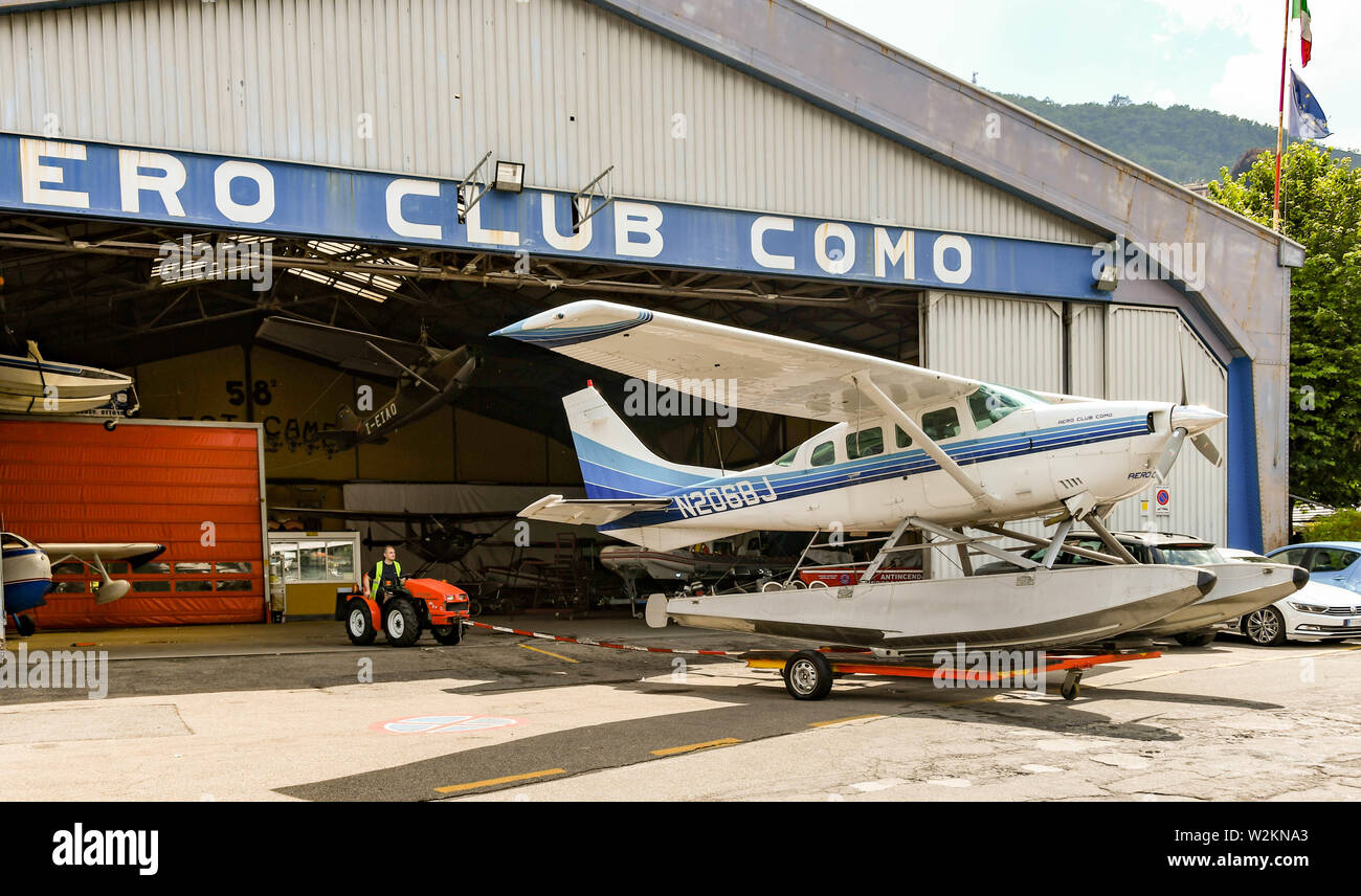 COMO, LAKE COMO, ITALY - JUNE 2019: Floatplane operated by the Aero Club Como being pushed from the hangar in the town of Como on Lake Como. Stock Photo