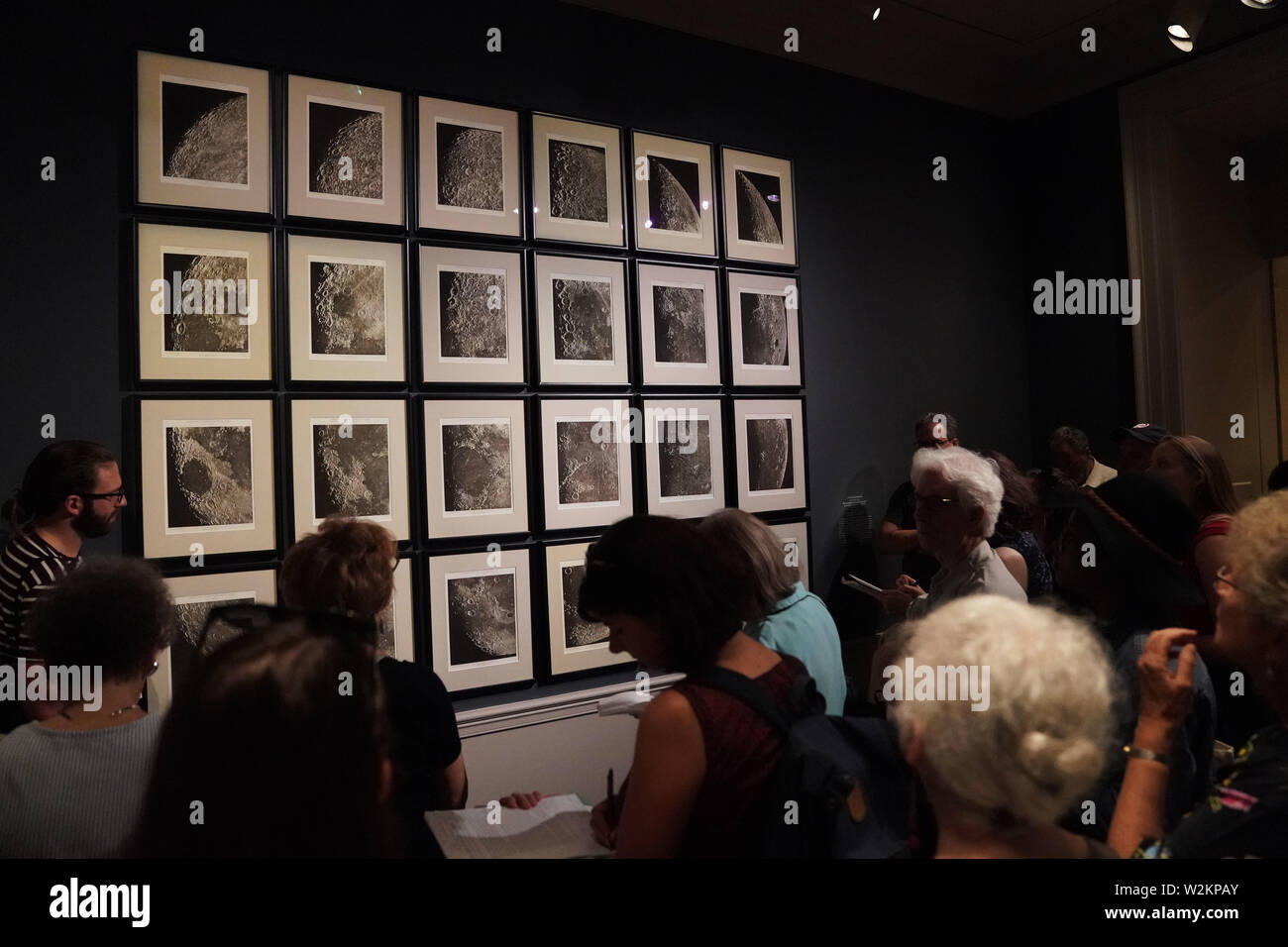 Washington, USA. 9th July, 2019. Visitors view 'Photographic and Systematic Chart of the Moon' exhibited during a preview of 'By the Light of the Silvery Moon: A Century of Lunar Photographs' at the National Gallery of Art in Washington, DC, the United States, on July 9, 2019. Some 50 works including a selection of photographs will be displayed in the exhibition lasting from July 14, 2019 through Jan. 5, 2020 to mark the 50th anniversary of the Apollo 11 moon landing. Credit: Liu Jie/Xinhua/Alamy Live News Stock Photo
