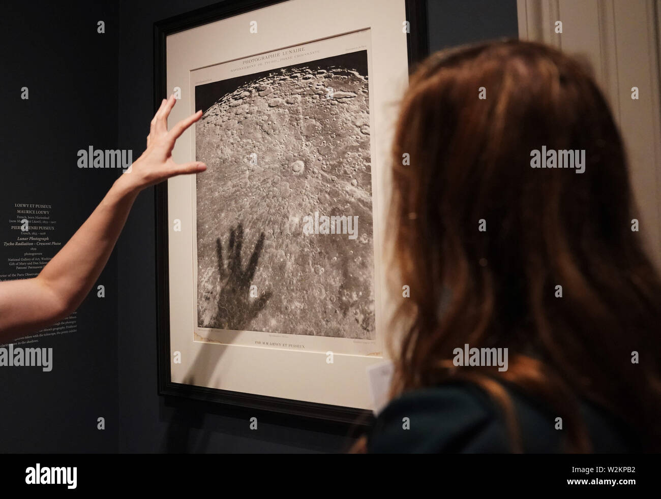 Washington, USA. 9th July, 2019. Visitors view a lunar photograph taken in 1899 during a preview of 'By the Light of the Silvery Moon: A Century of Lunar Photographs' at the National Gallery of Art in Washington, DC, the United States, on July 9, 2019. Some 50 works including a selection of photographs will be displayed in the exhibition lasting from July 14, 2019 through Jan. 5, 2020 to mark the 50th anniversary of the Apollo 11 moon landing. Credit: Liu Jie/Xinhua/Alamy Live News Stock Photo
