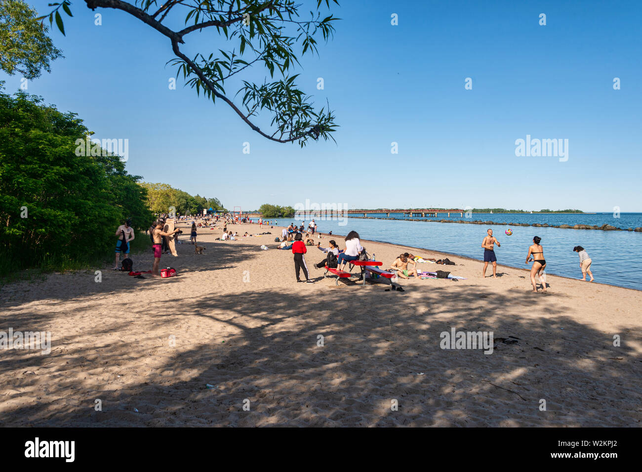 Toronto, CA - 23 June 2019: People enjoying a warm summer day at the beach on Centre island. Stock Photo
