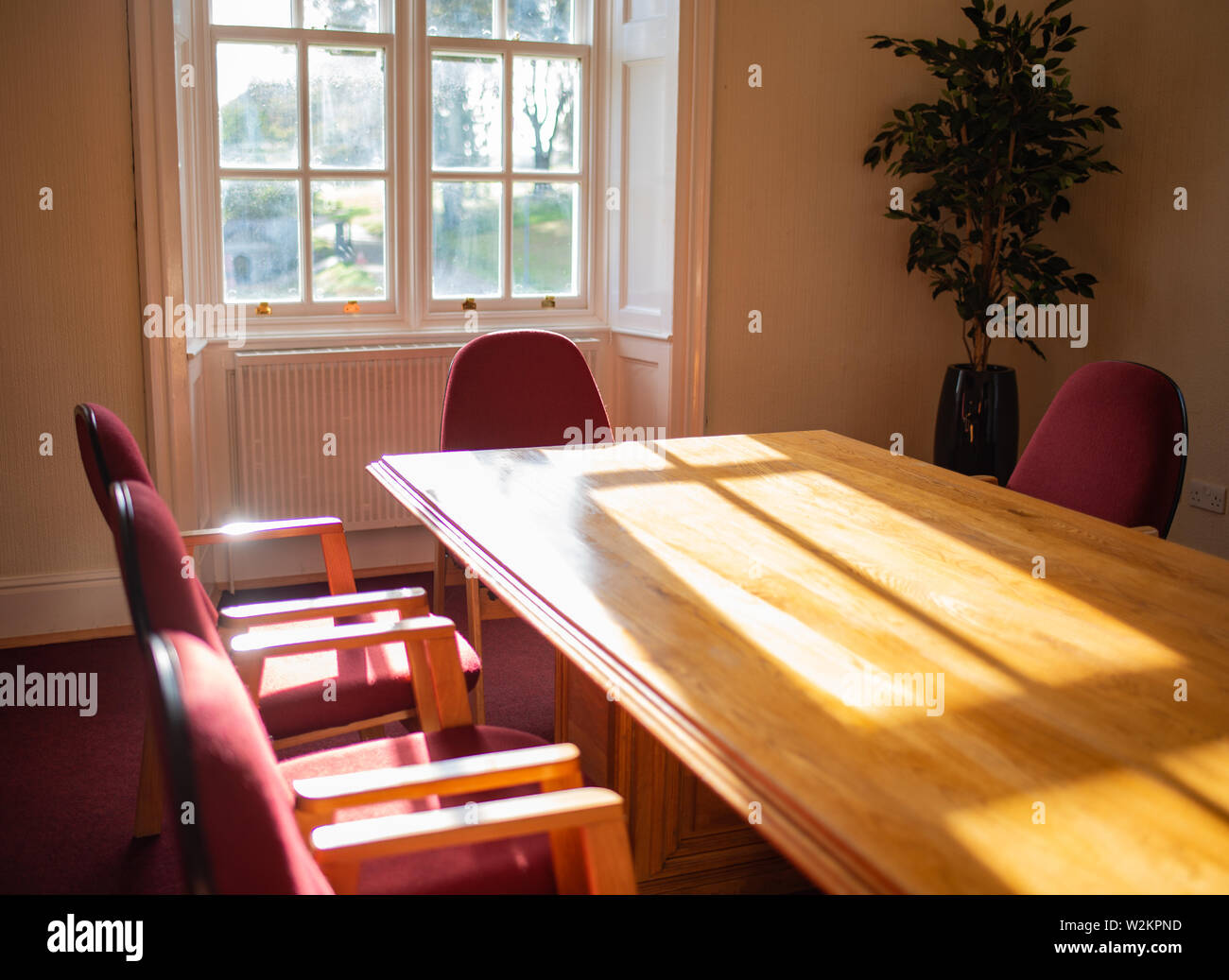 Empty conference room with sun shining through window, old building Stock Photo