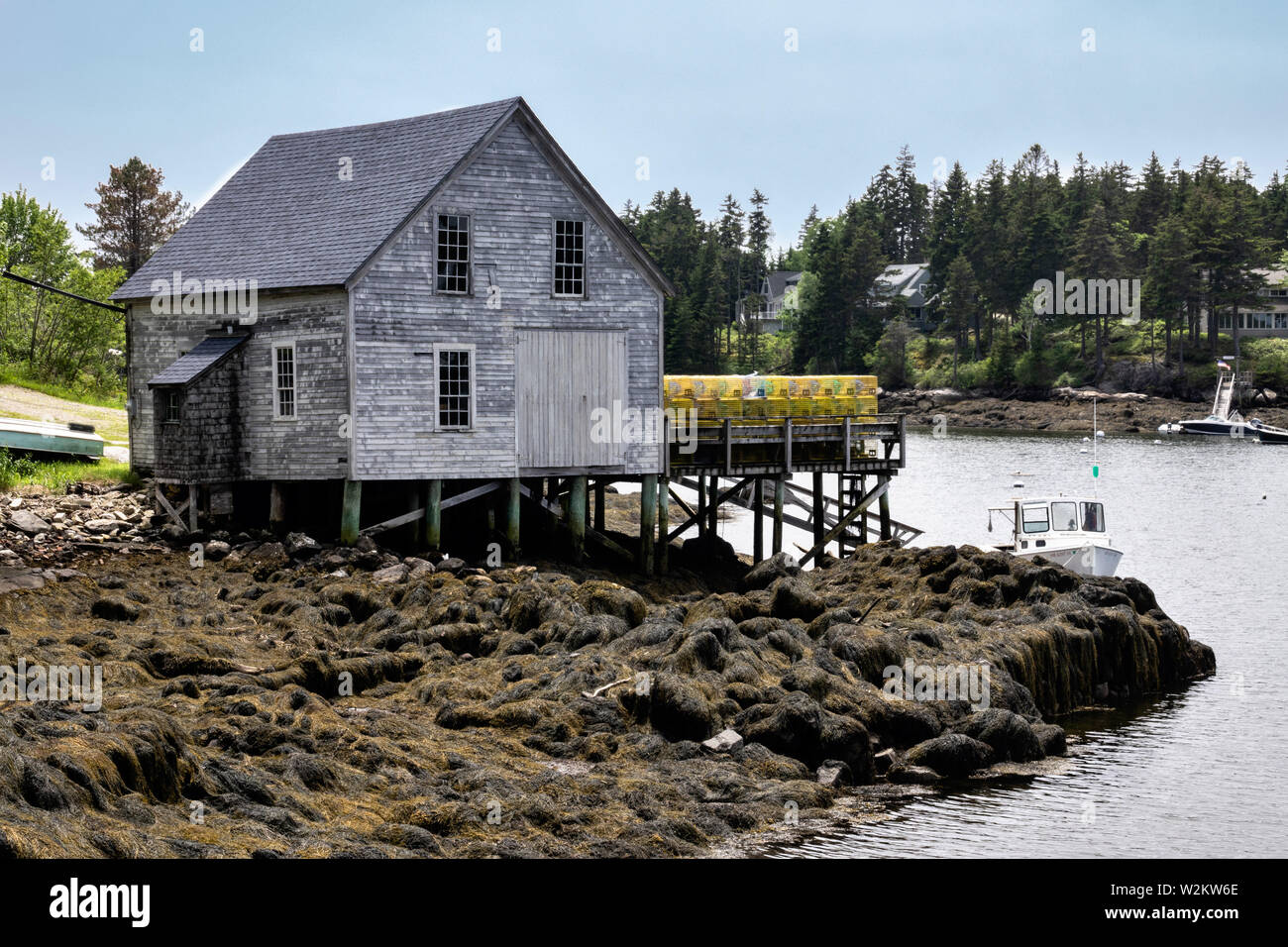 A boat house and lobster wharf piled high with traps in the tiny