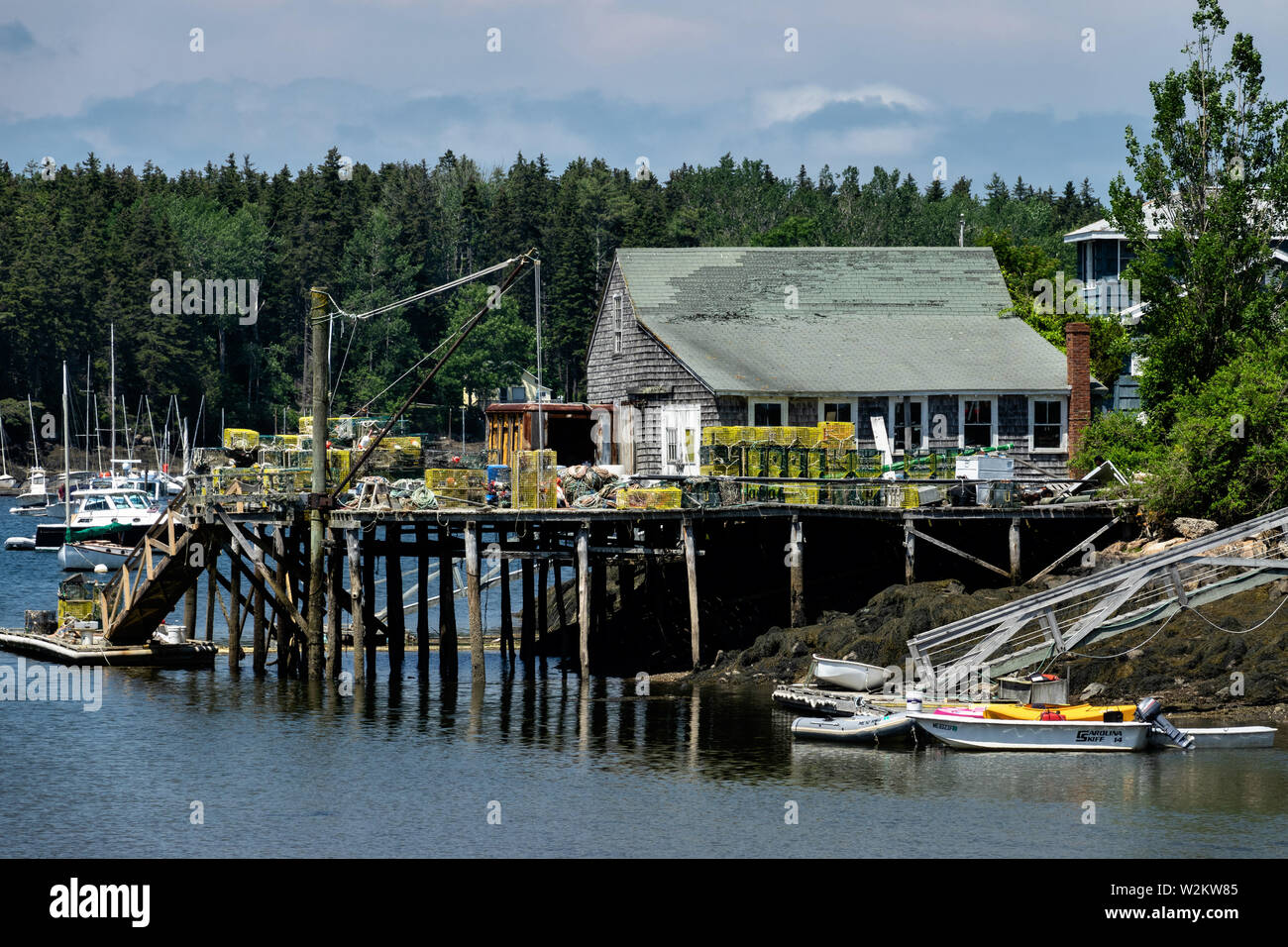 A lobster wharf piled with traps and fishing gear in the tiny village