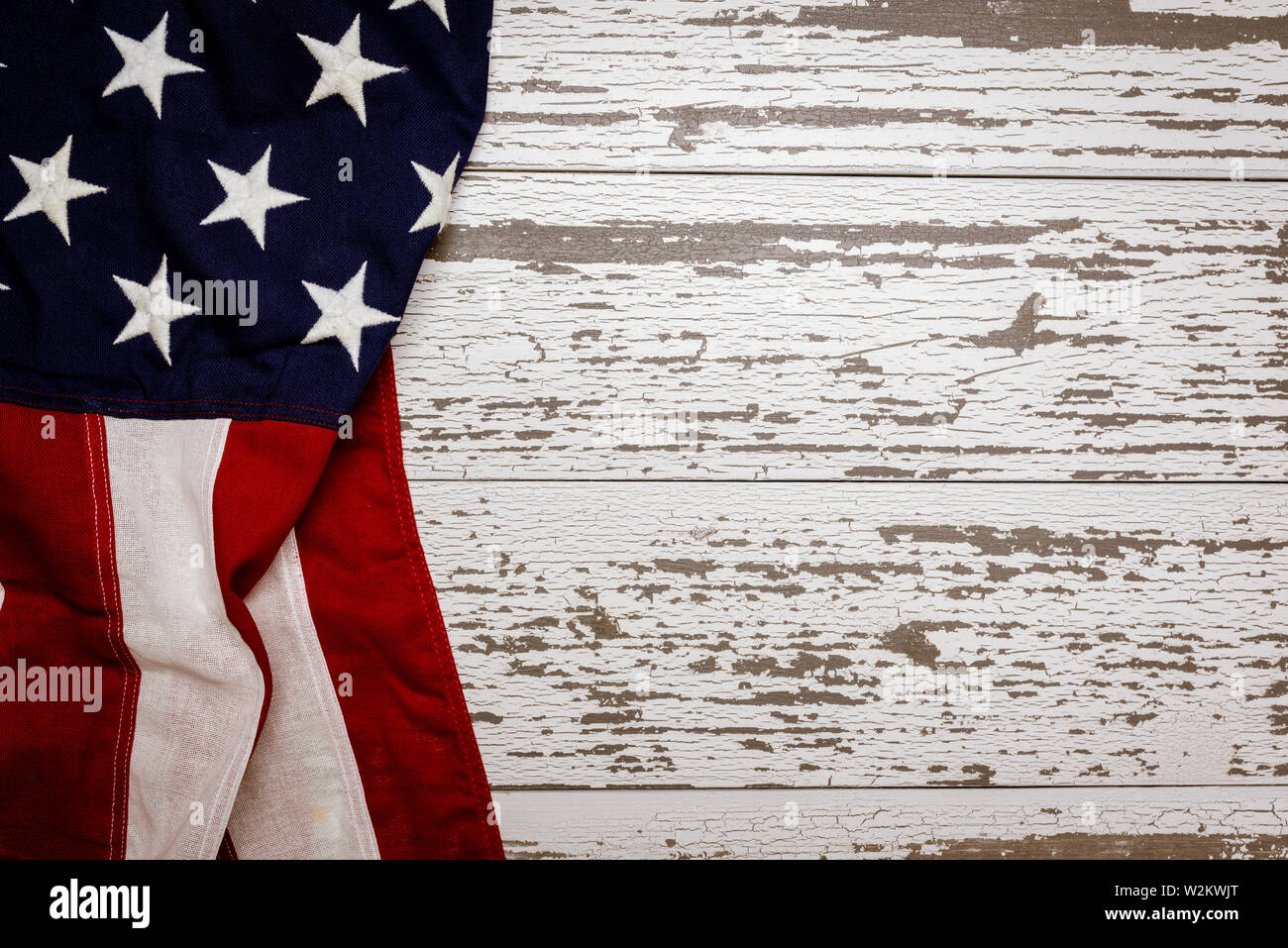 A crumpled American flag on a white plank background with copy space for holidays etc. Stock Photo