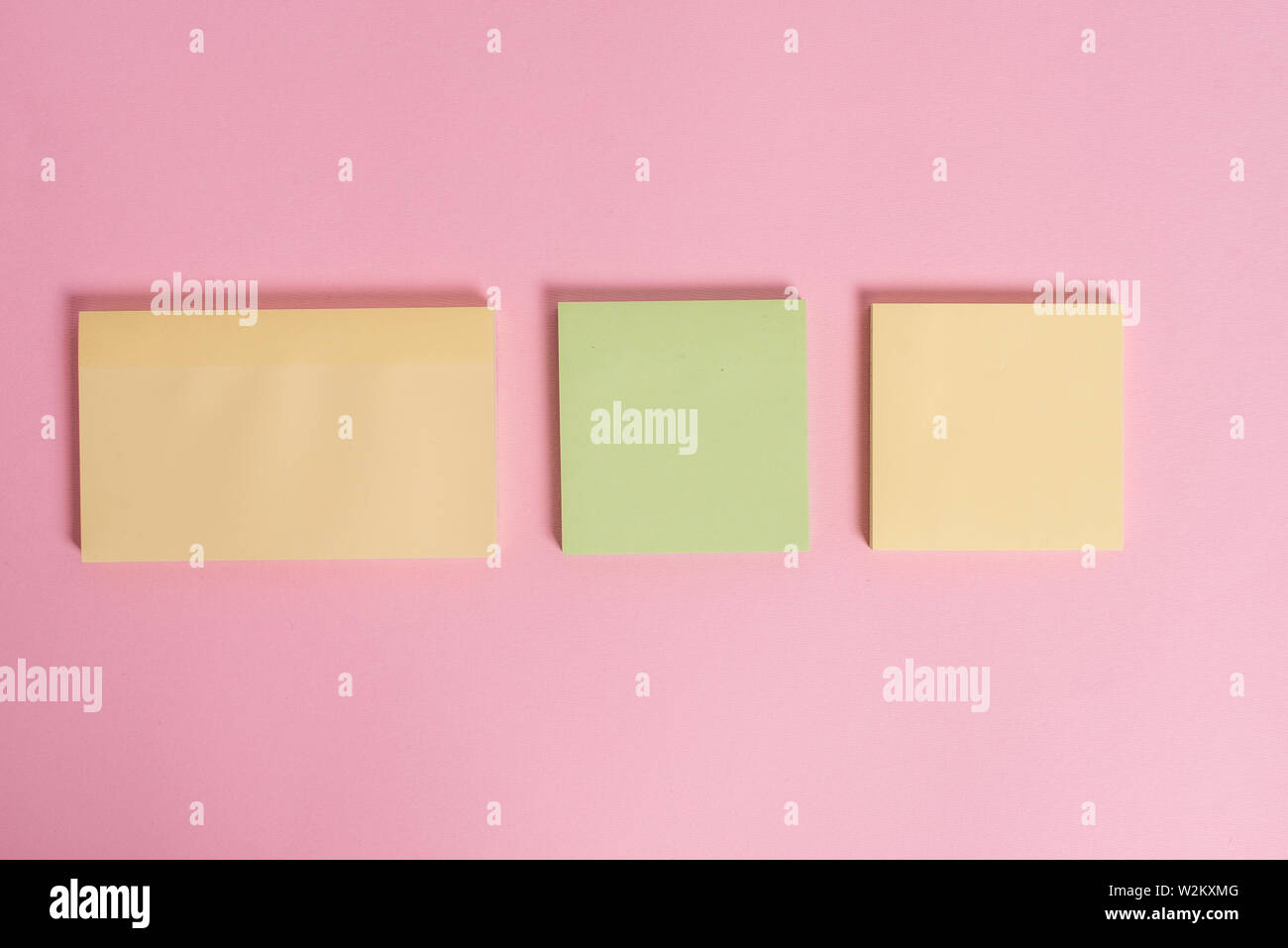 Close up front view three multicolor blank notepads colored background Stock Photo