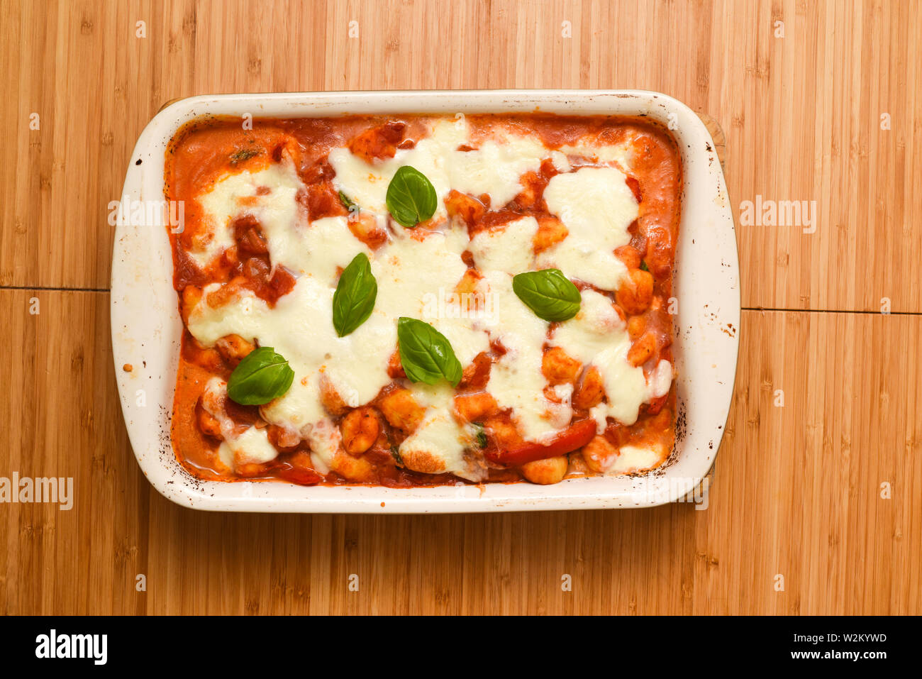 Italian pasta bake meal with melted mozzarella cheese topping on tasty