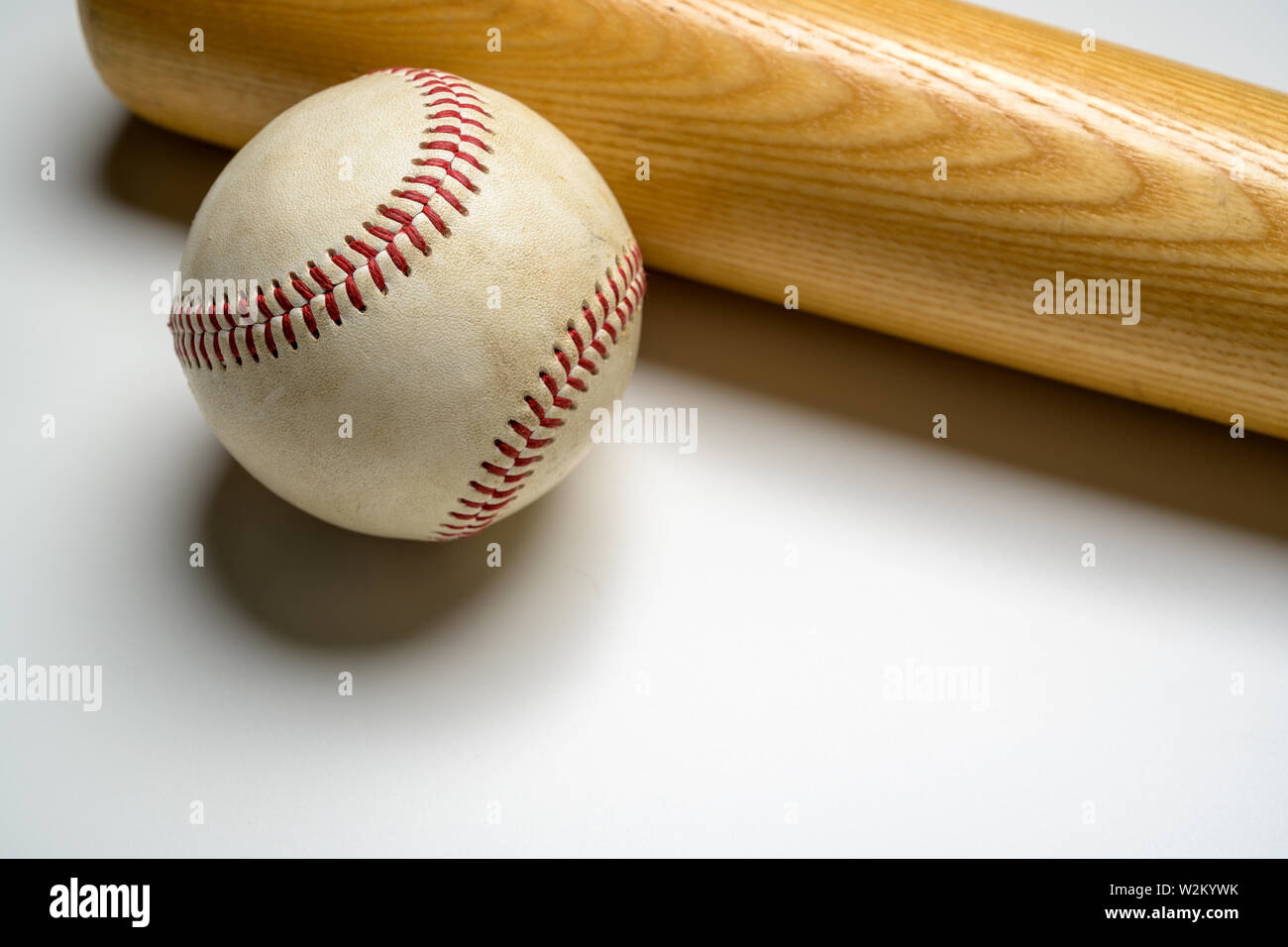 A wooden baseball bat and leather ball on white background Stock Photo