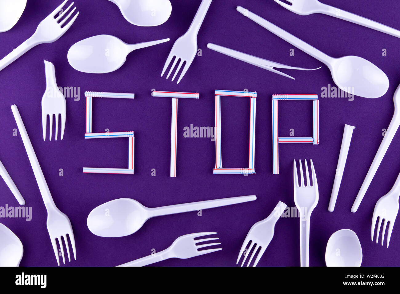 The word stop made of plastic tubes on a purple background with plastic