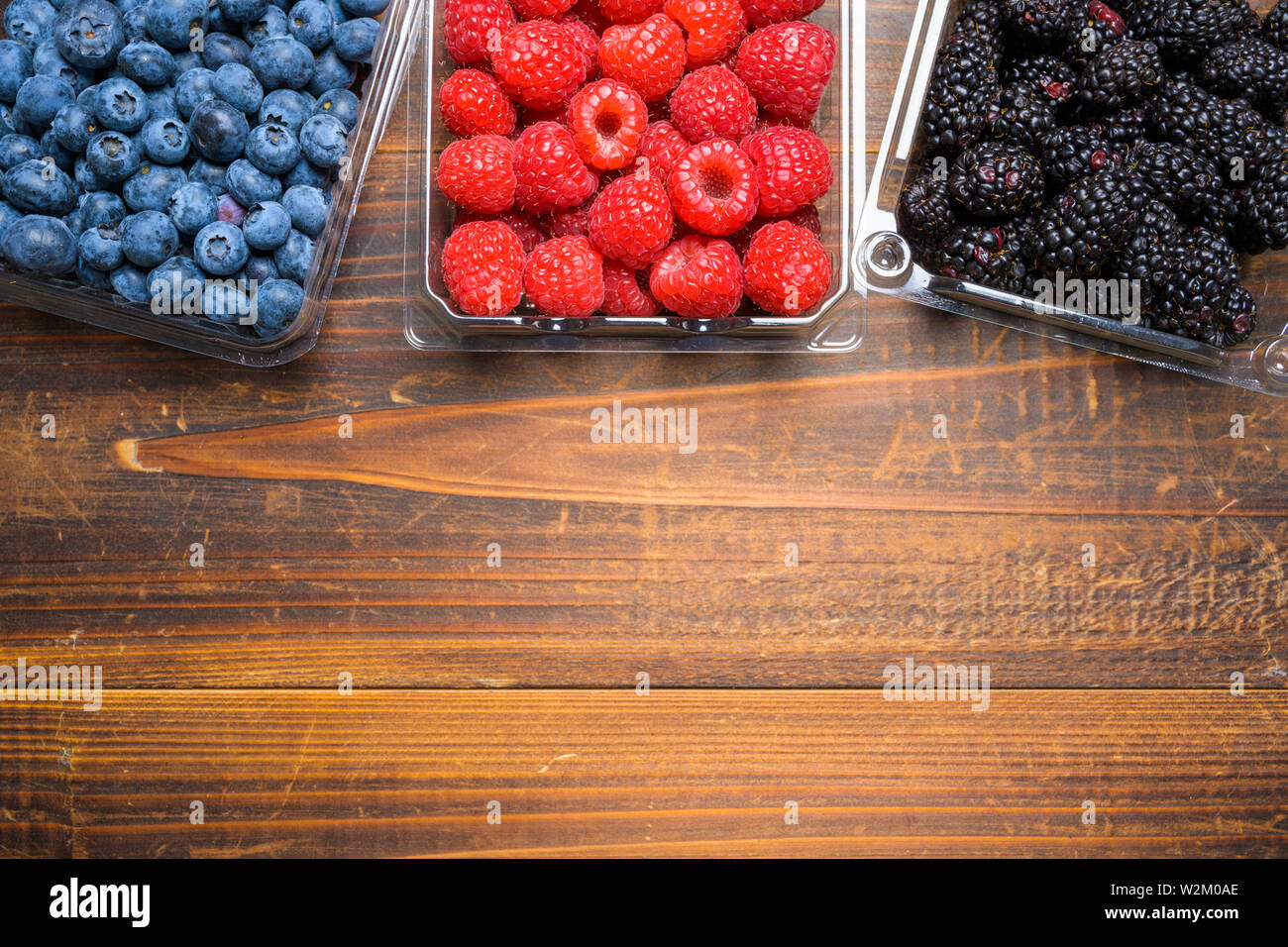 Assorted Berries on wood background Stock Photo