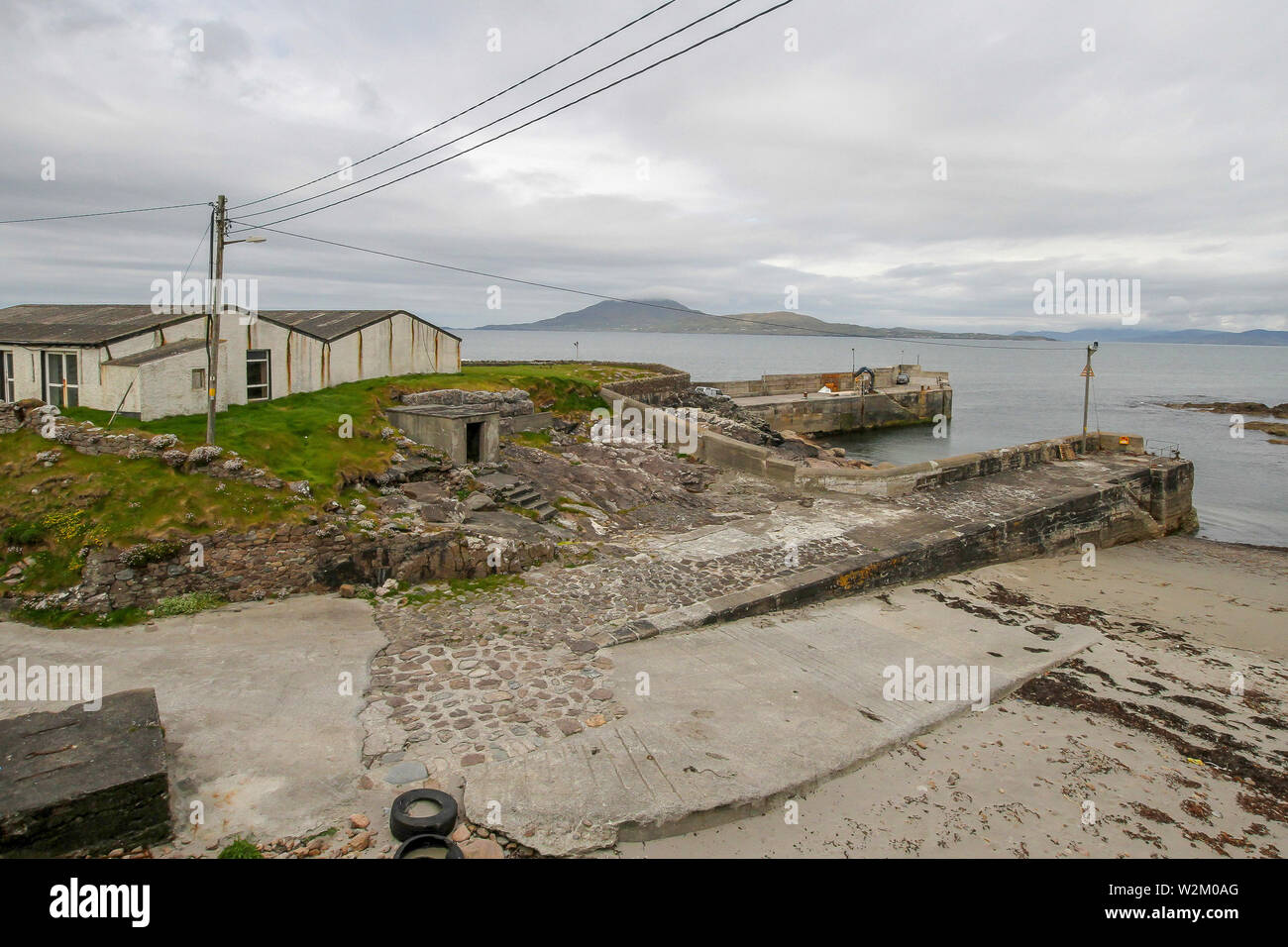 Harbour and quays at low tide in Ireland. Roonagh Quay near Louisburgh County Mayo provides the mainland base for the Clare Island ferry service. Stock Photo