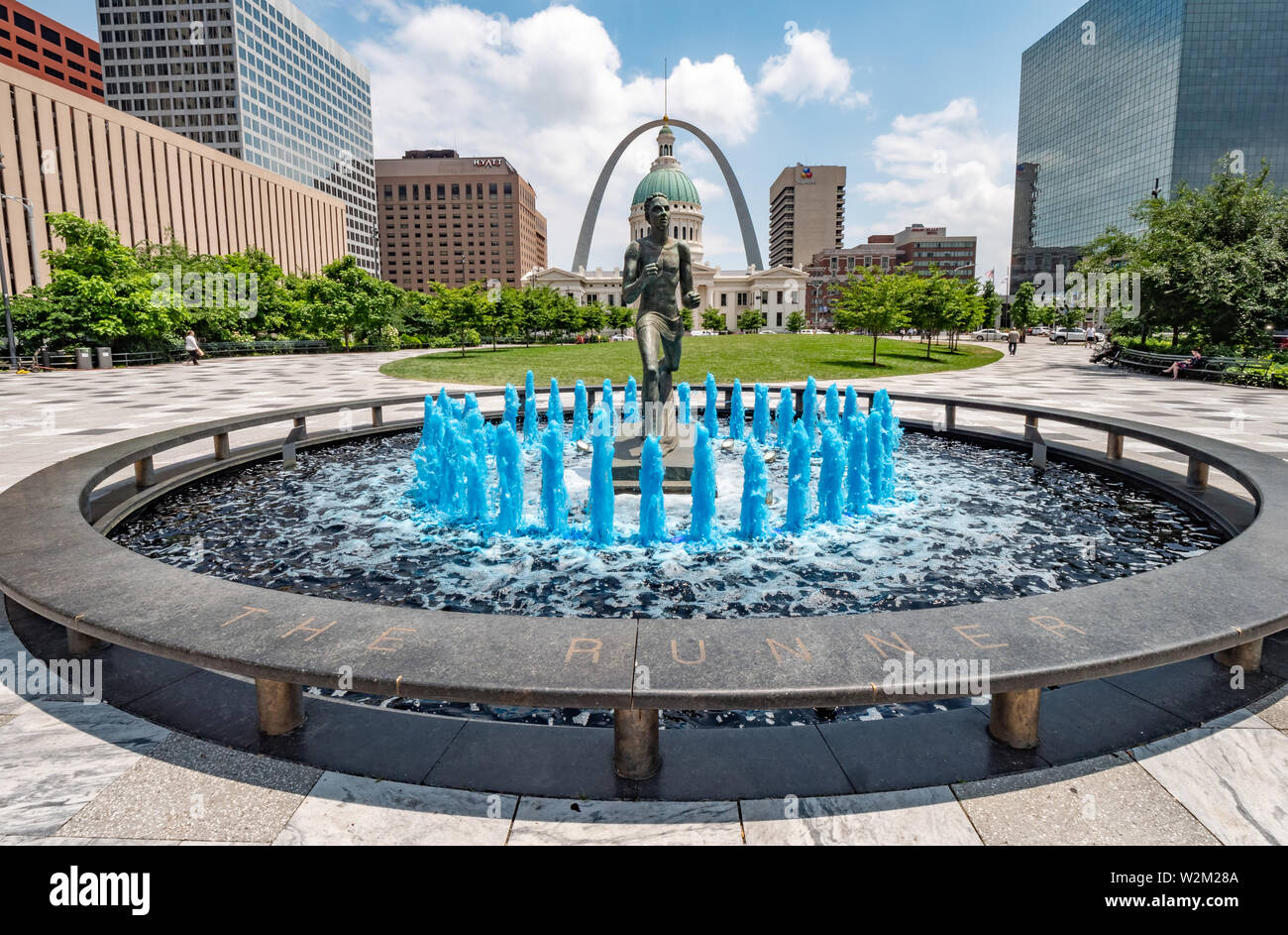 Blue water fountain with Runner Statue at Kiener Plaza Park in St