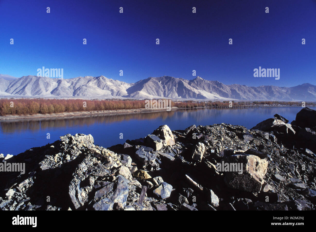 The River Lhasa And The Brahmaputra River Locally Known As Yarlung Tsang Bo Meet Near The Lhasa City Though Trees Grow Next To The River The Mountain Sides Are Bare And Very