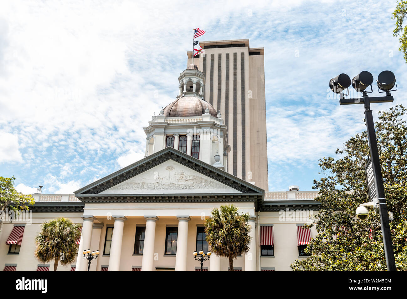 Tallahassee, USA - April 26, 2018: Exterior state capitol building in Florida during day with modern architecture of government and lamp and palm tree Stock Photo