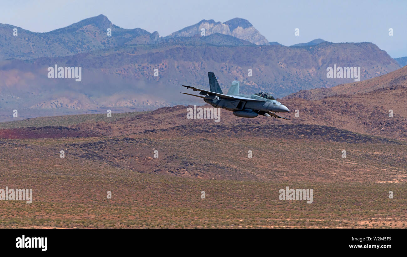 Airplane F-18 jet fighter flying at Star Wars Canyon at Death Valley, California Stock Photo