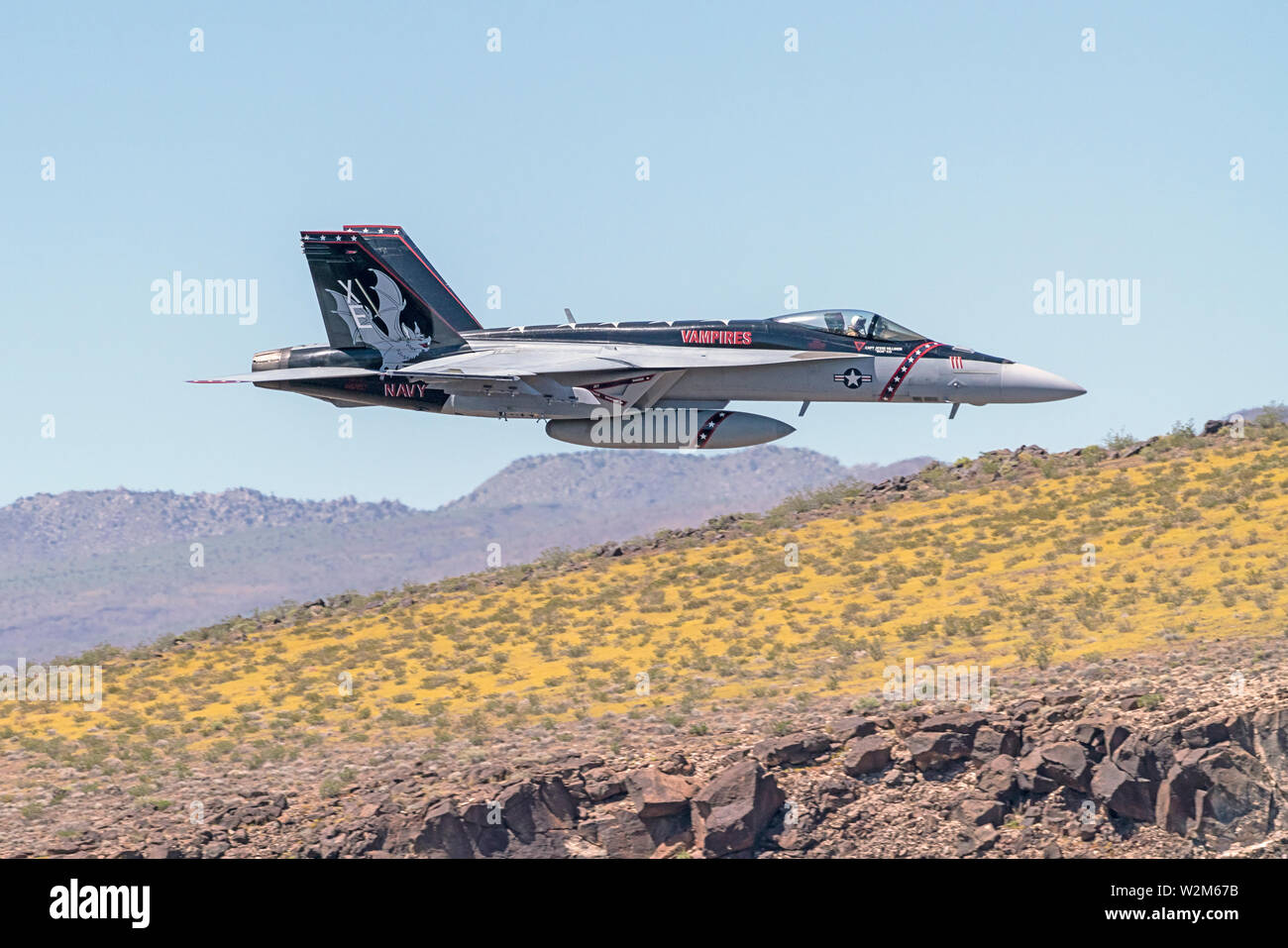 Airplane F-18 jet fighter flying at Star Wars Canyon at Death Valley, California Stock Photo