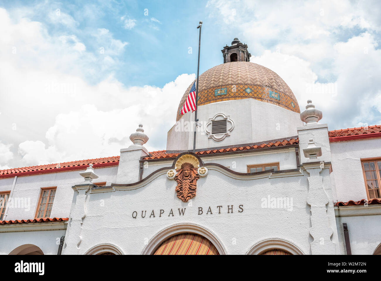 Hot Springs, USA - June 4, 2019: Historical Quapaw Baths Spa bath house with American flag and dome in city Stock Photo