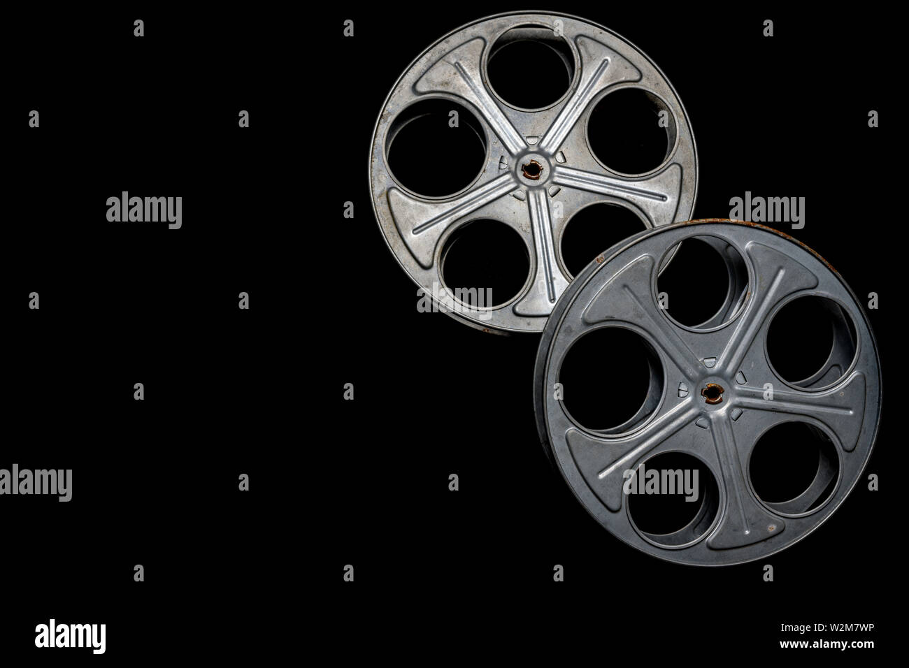 https://c8.alamy.com/comp/W2M7WP/two-vintage-film-reels-on-a-black-background-with-copy-space-W2M7WP.jpg
