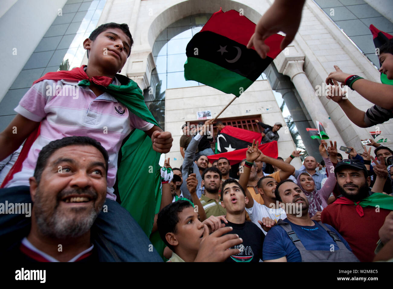 October 20, 2011 – Tunis, Tunisia - A number of Libyan nationals have gathered outside the Libyan embassy in Tunis, to celebrate the reports that Muammar Gaddafi had been captured, possibly killed in his home town of Sirt, where rebels have fought a grueling battle for weeks to crush his remaining armed loyalists. Photo credit: Benedicte Desrus Stock Photo