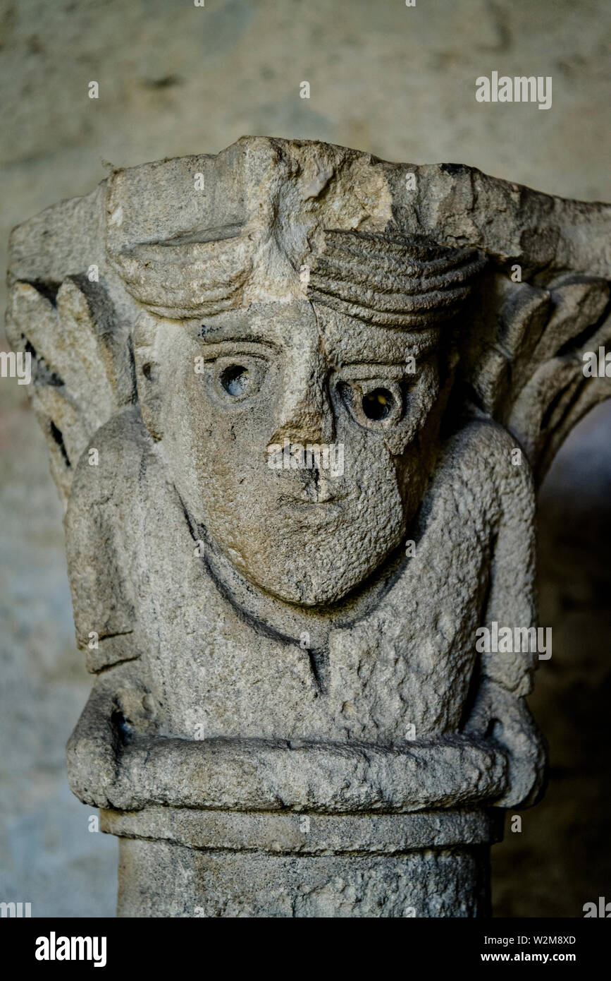 Medieval sculture placed on top of the column or capital in the Romanesque church Cloister of the de Saint-Andre-le-Bas, Vienne, France Stock Photo