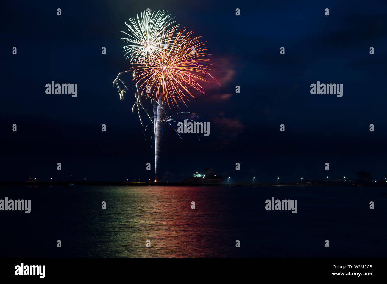 The 4th of July fireworks reflect in the waters of Crescent City Harbor on the Pacific Ocean in Crescent City, California, USA. Stock Photo