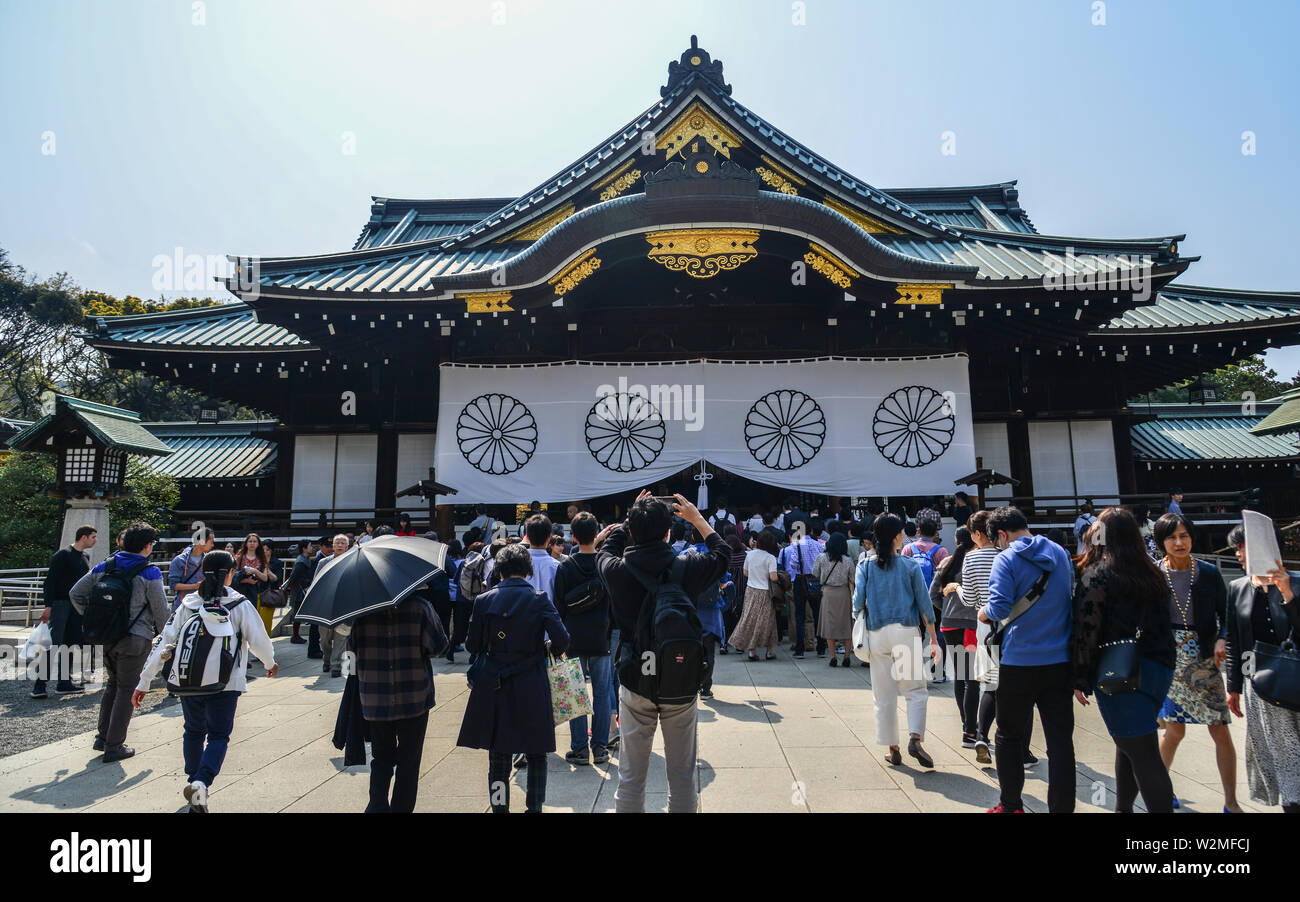Tokyo, Japan - Apr 7, 2019. People visit Yasukuni Shrine in sunny day. The shrine is a place to worship many war criminals, including important WW2 mi Stock Photo