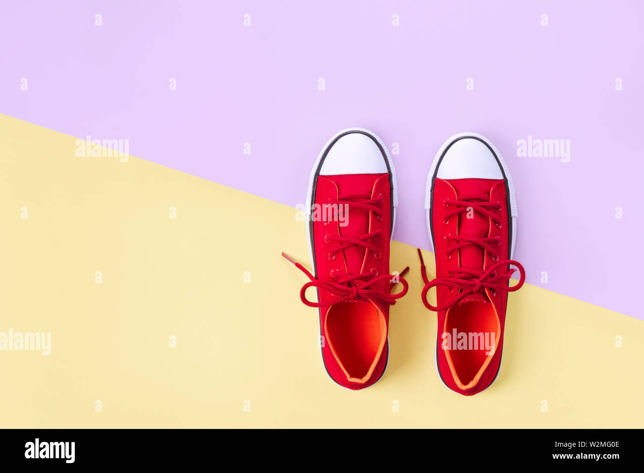 New red sneakers on yellow and violet background with copy space Stock ...