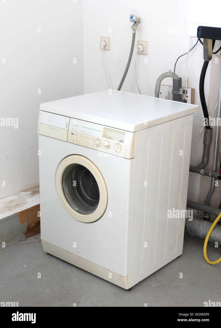 Old dirty washing machine on the attic, door closed Stock Photo - Alamy