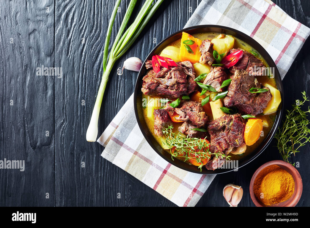 traditional Jamaican Curry Goat slow cooked Jamaican Spiced meat and vegetables spicy Curry in