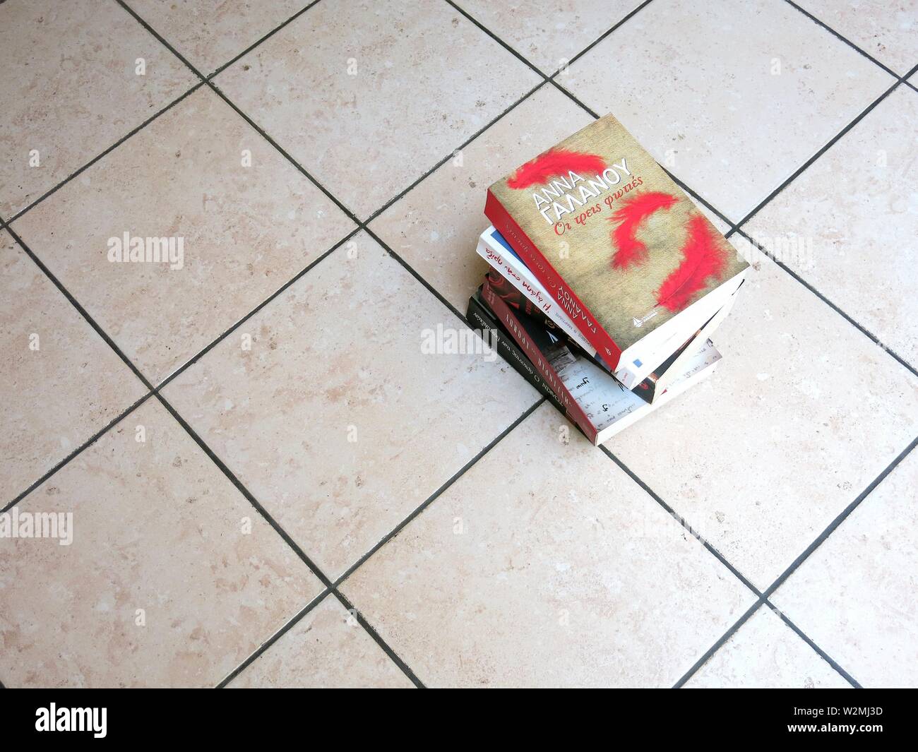 Stack of books on the floor Stock Photo Alamy
