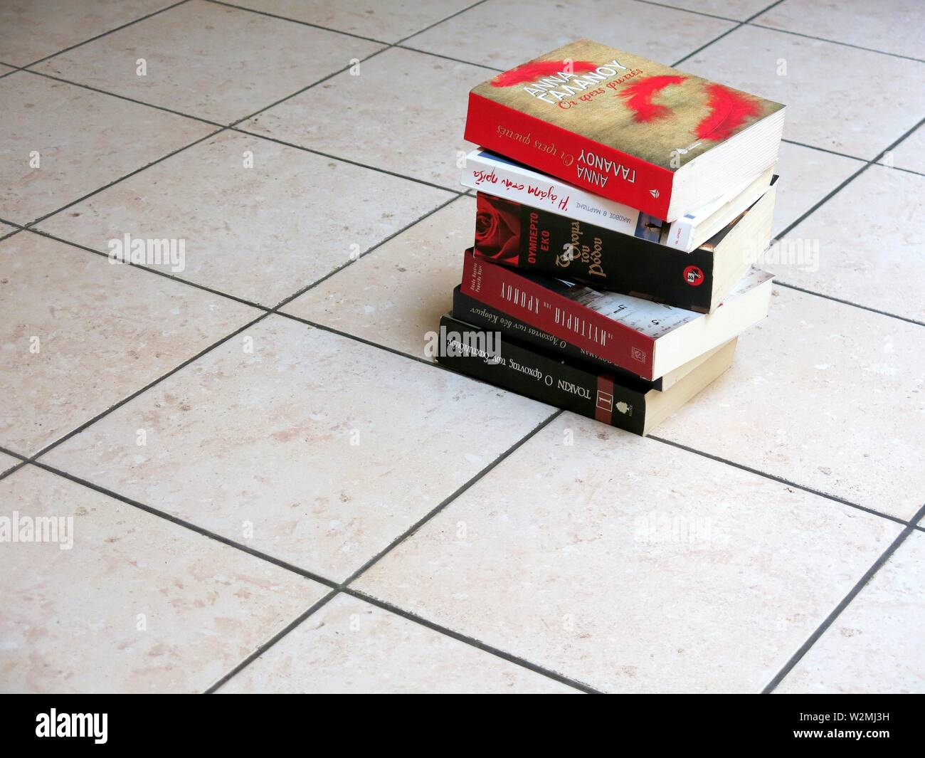 Stack of books on the floor Stock Photo Alamy