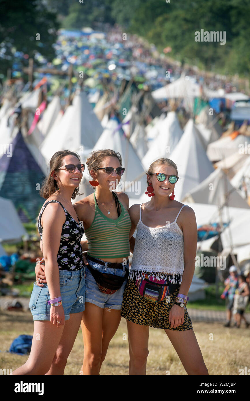Festival-goers pose for a picture above the Tipi Village at Glastonbury 2019 Stock Photo