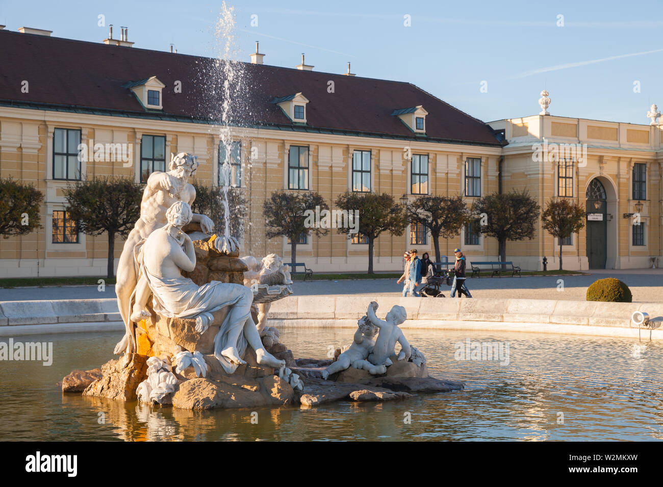 Vienna, Austria - November 1, 2015: Fountain at the entrance of the Schonbrunn Palace. It is a former imperial summer residence of successive Habsburg Stock Photo