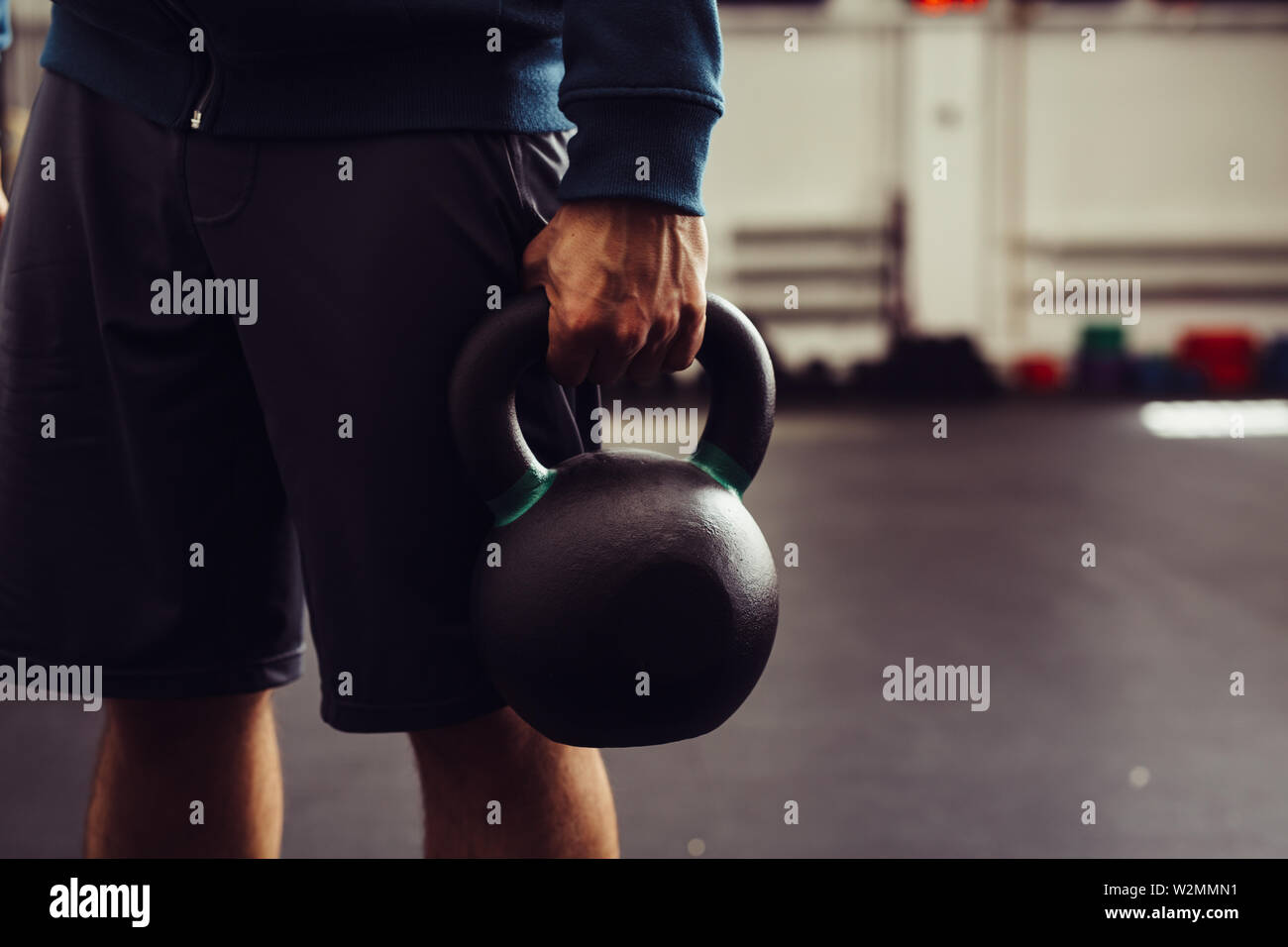 Close up shot of man holding kettlebell in gym Stock Photo