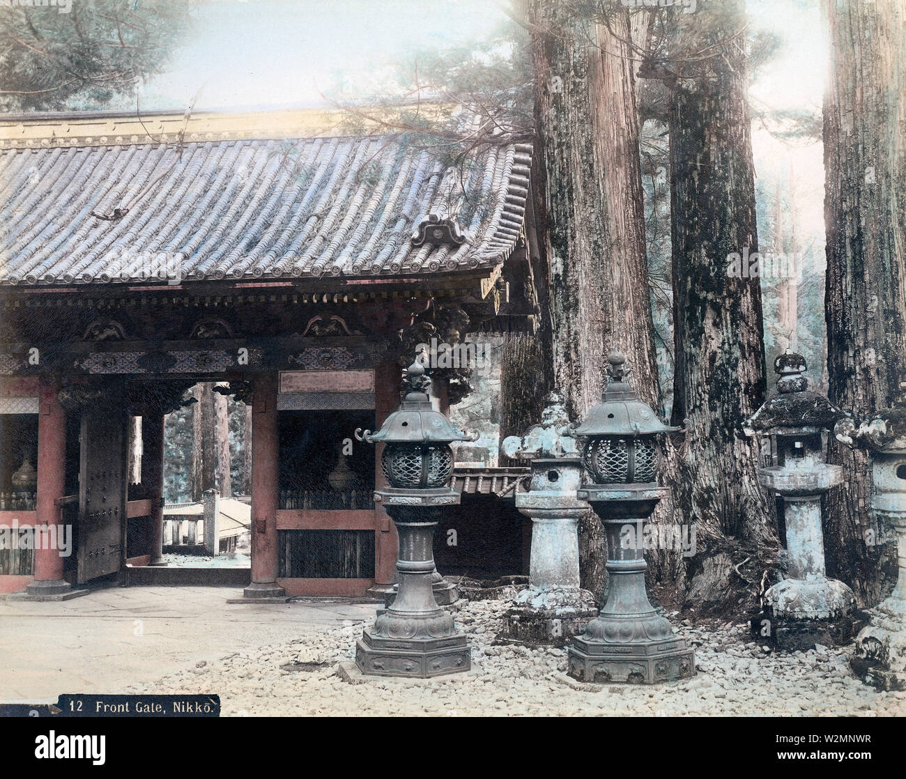 [ 1890s Japan - Lanterns at Niomon Gate, Nikko ] —   A rare view of Niomon in Nikko, as seen from the back. The gate was also known as Omotemon or Front Gate. The pots visible in the gate were displayed there between 1871 (Meiji 4) and 1897 (Meiji 30).  19th century vintage albumen photograph. Stock Photo