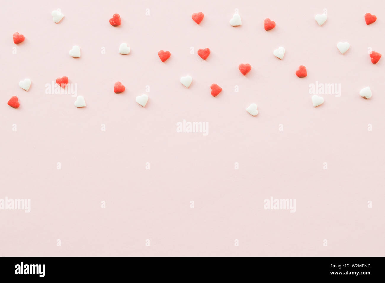 Valentine's Day background with red and white little hearts on pink ...