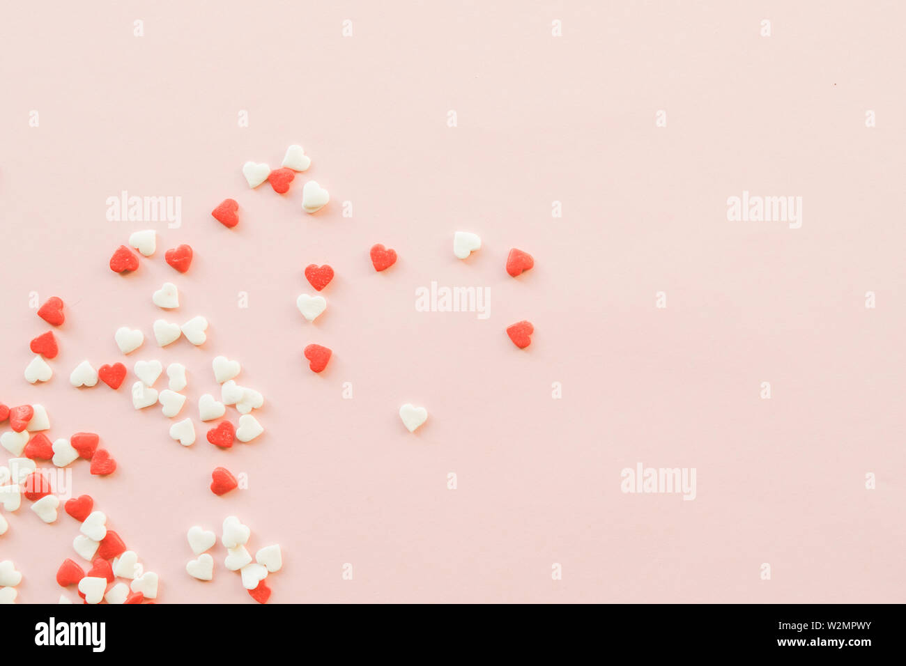 Valentine's Day background with red and white little hearts on pink ...
