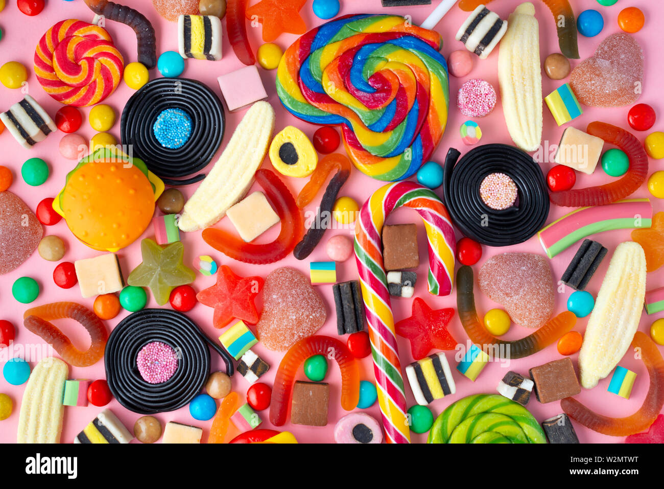background of lollipops and candies on pink Stock Photo - Alamy