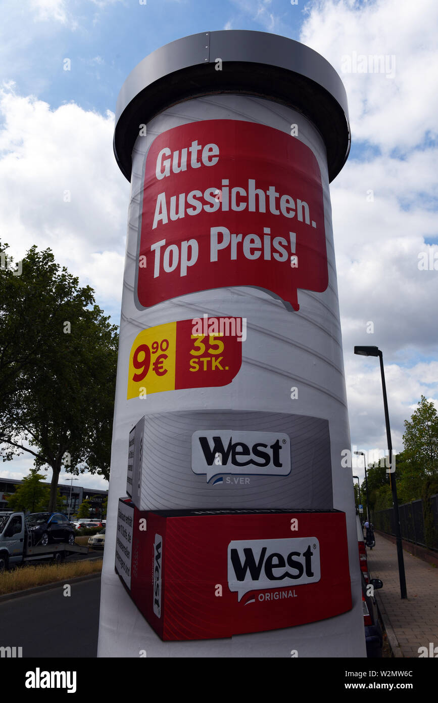 09 July 2019, North Rhine-Westphalia, Duesseldorf: A poster with tobacco  advertising hangs on an advertising pillar. Germany is the last EU country  to allow tobacco advertising on advertising pillars and billboards. The