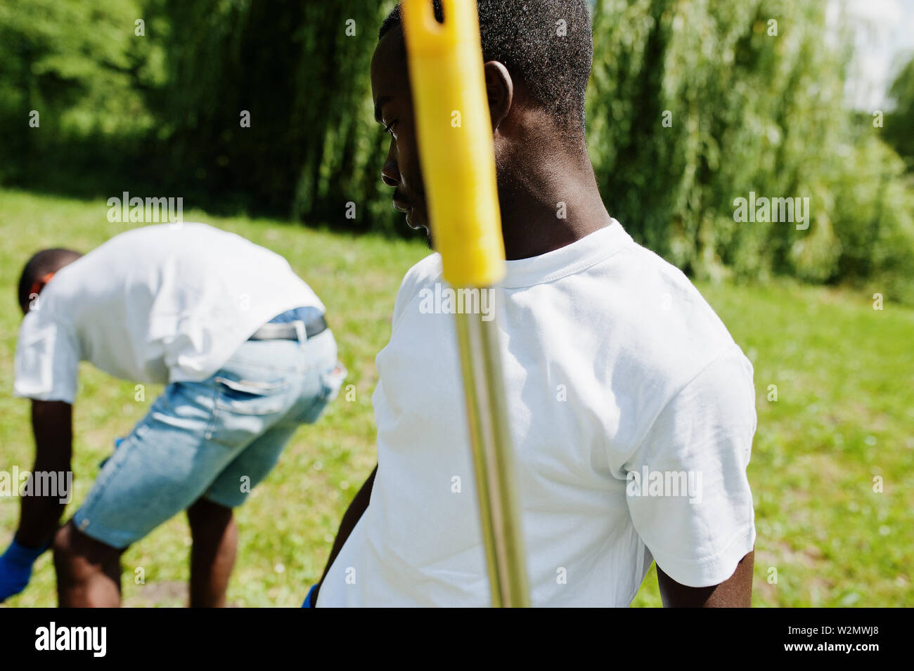 Group of happy african volunteers planting tree in park. Africa