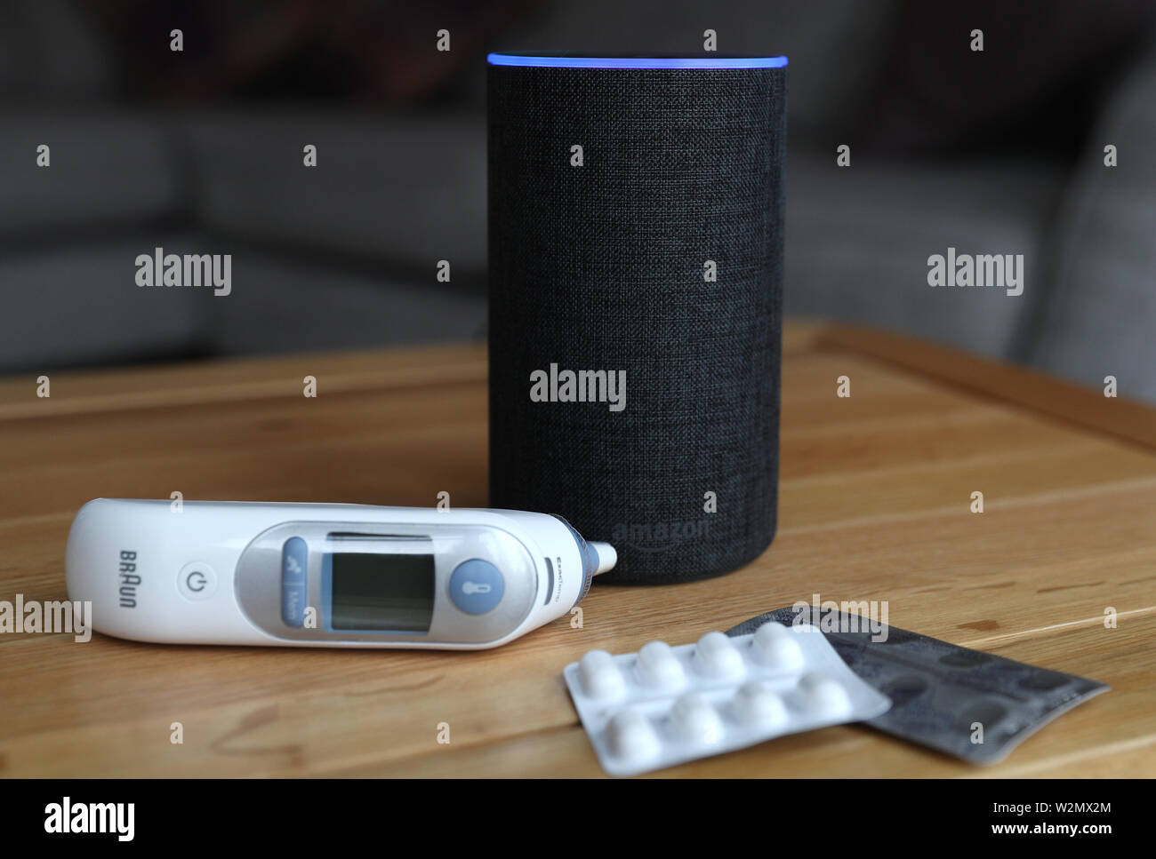 A general view of an  Echo smart speaker alongside an ear thermometer  and some pills. 's Alexa is set to answer people's health queries by  searching the official NHS website Stock
