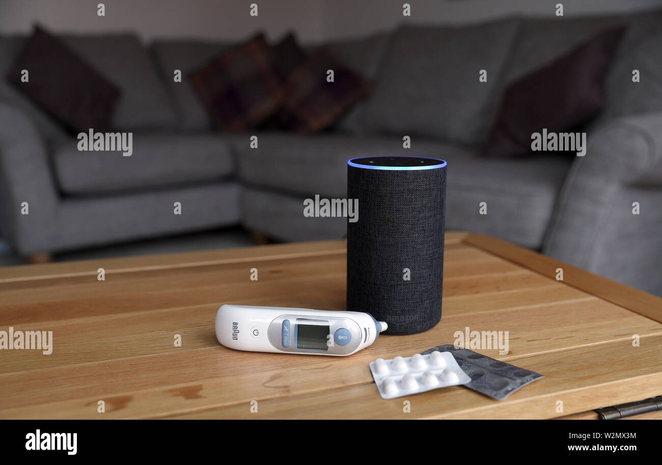 A general view of an  Echo smart speaker alongside an ear thermometer  and some pills. 's Alexa is set to answer people's health queries by  searching the official NHS website Stock