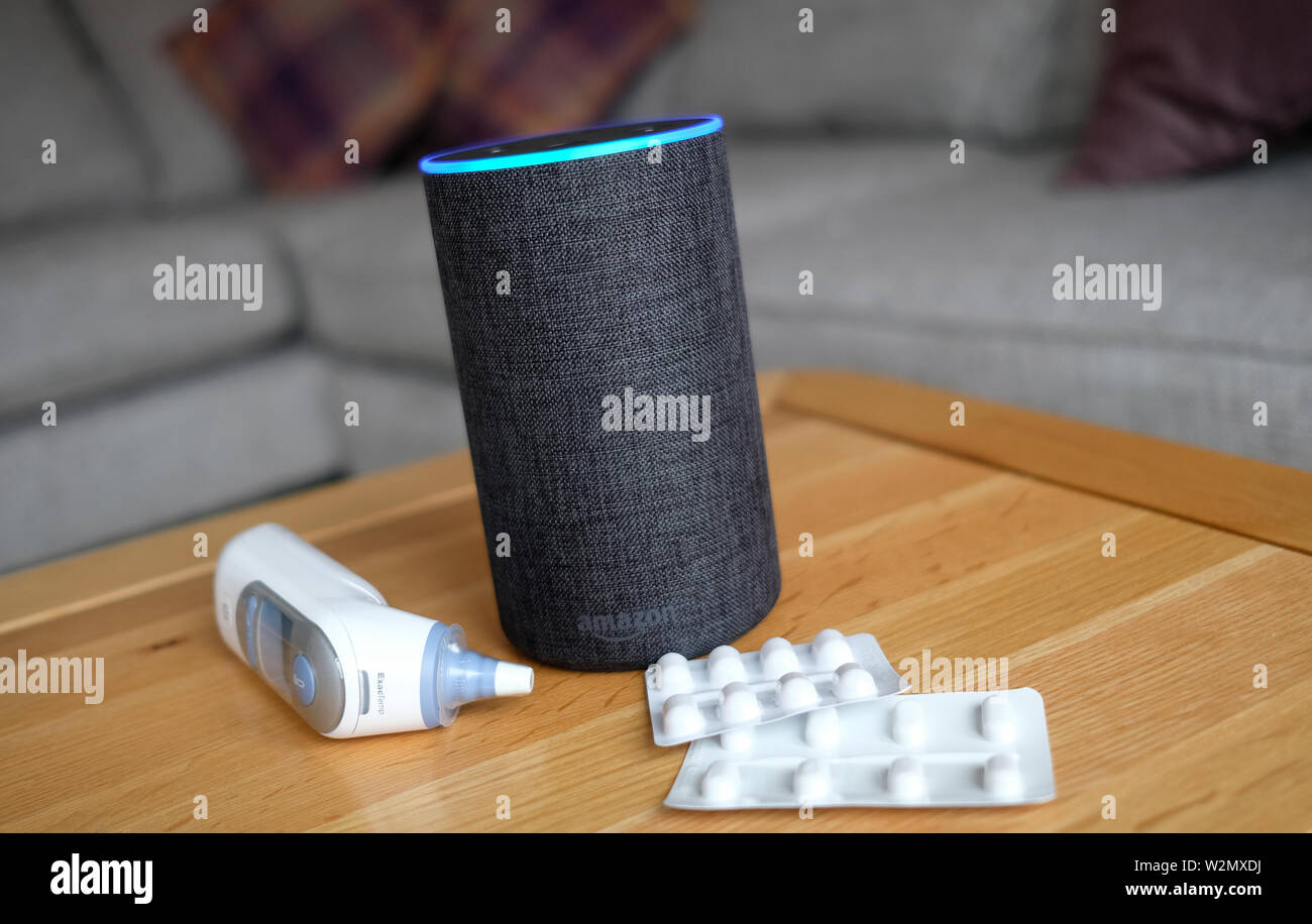 https://c8.alamy.com/comp/W2MXDJ/a-general-view-of-an-amazon-echo-smart-speaker-alongside-an-ear-thermometer-and-some-pills-amazons-alexa-is-set-to-answer-peoples-health-queries-by-searching-the-official-nhs-website-W2MXDJ.jpg