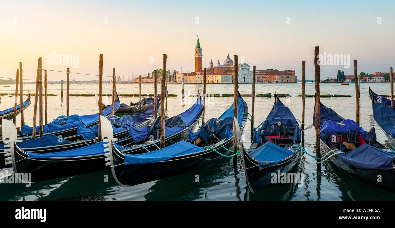 Moored Gondolas at venetian sunrise in front of San Giorgio Maggiore. Stock Photo