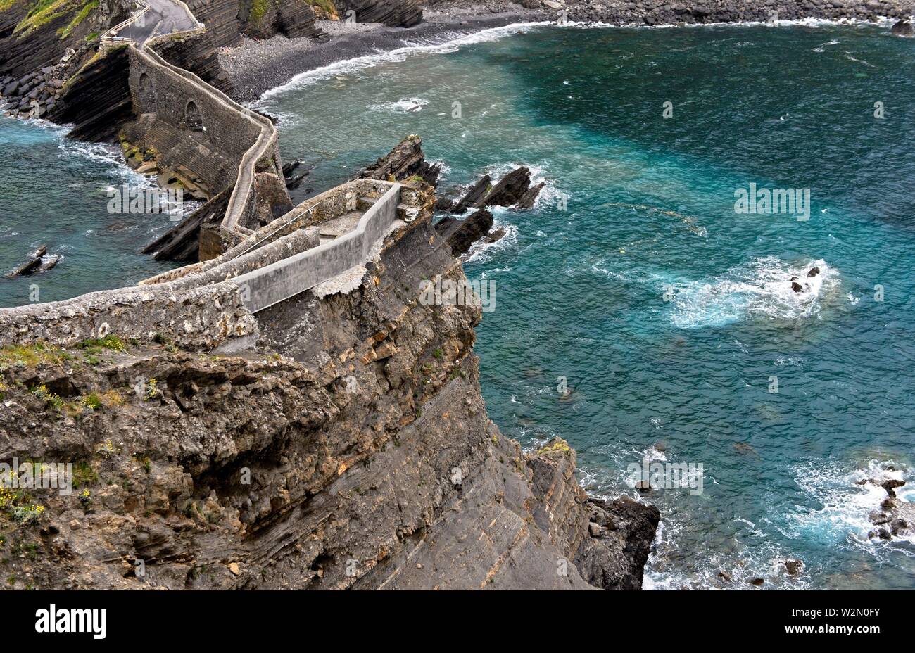 Stone bridge and narrow cliff trail above the Bay of Biscaya on the