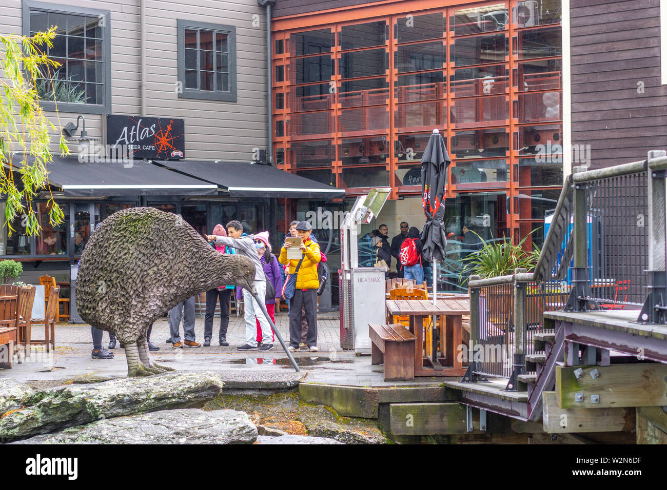 Tourists photographing Kiwi sculpture at Tourist wharf, Lake Wakatipu,  Queenstown New Zealand Stock Photo