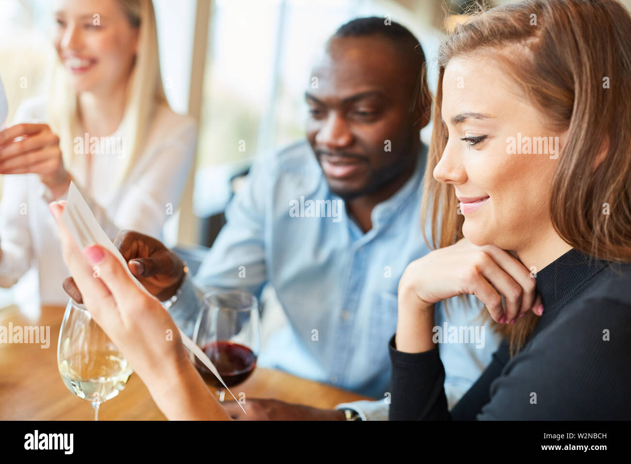 Young couple looks at the menu in the restaurant or bistro when ordering Stock Photo